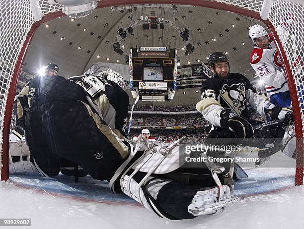 Maxime Talbot Pittsburgh Penguins battles for the puck against Brian Gionta of the Montreal Canadiens in front of Marc-Andre Fleury in Game Five of...