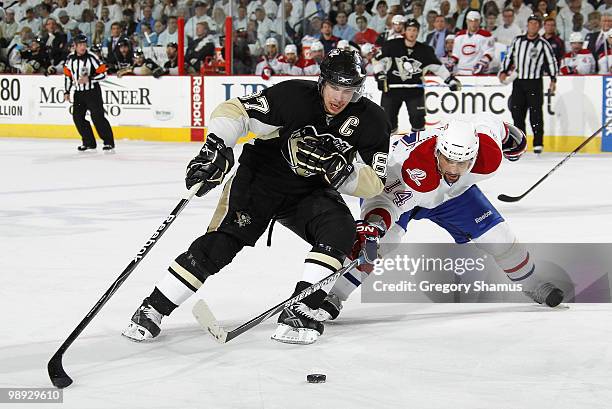 Sidney Crosby of the Pittsburgh Penguins moves the puck in front of the defense of Tomas Plekanec of the Montreal Canadiens in Game Five of the...