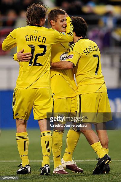 Eddie Gaven, Robbie Rogers and Guillermo Barros Schelotto of the Columbus Crew celebrate an own goal by the New England Revolution on May 8, 2010 at...