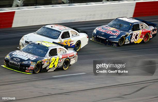 Jeff Gordon, driver of the DuPont / National Guard Chevrolet, leads Michael McDowell, driver of the PRISM Motorsports Toyota and Brian Vickers,...