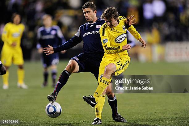 Chris Tierney of the New England Revolution and Eddie Gaven of the Columbus Crew battle for control of the ball on May 8, 2010 at Crew Stadium in...