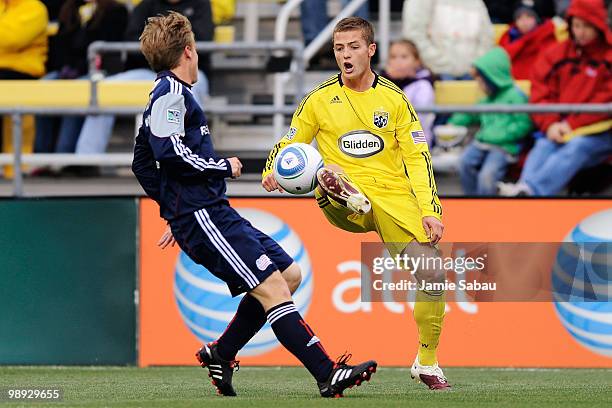 Robbie Rogers of the Columbus Crew takes control of the ball in front of Seth Sinovic of the New England Revolution on May 8, 2010 at Crew Stadium in...