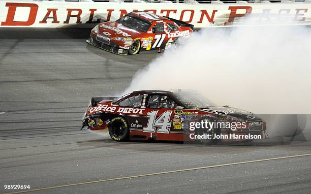 Smoke pours out the back of the Old Spice / Office Depot Chevrolet driven by Tony Stewart on track during the NASCAR Sprint Cup series SHOWTIME...