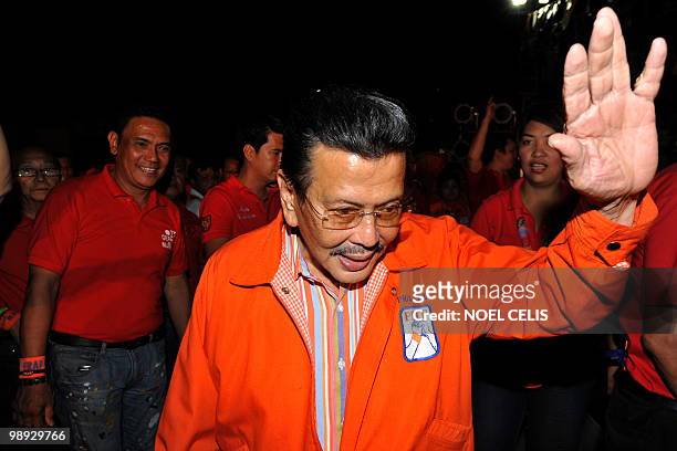 To go with profile story Philippines-politics-vote-Estrada Philippine Presidential candidate and former president Joseph Estrada waves to his...