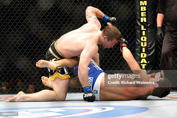 Alan Belcher punches Patrick Cote in their middleweight bout at UFC 113 at Bell Centre on May 8, 2010 in Montreal, Quebec, Canada.