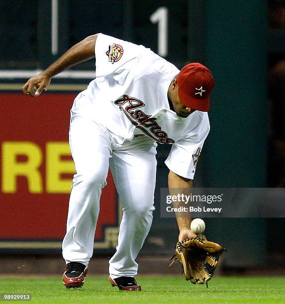Left fielder Carlos Lee of the Houston Astros misplays a ball off his glove against the San Diego Padres at Minute Maid Park on May 8, 2010 in...