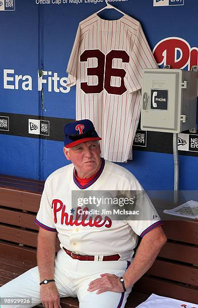 Manager Charlie Manuel of the Philadelphia Phillies sits in the dugout next to a jersey of Phillies Hall of Fame pitcher Robin Roberts prior to...