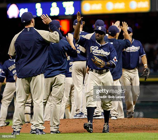 Tony Gwynn, of the San Diego Padres, right, receives a high five at the end of the game as the San Diego Padres beat the Houston Astros 2-1 at Minute...