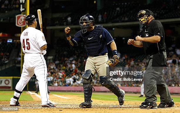 Catcher Yorvit Torrealba of the San Diego Padres pumps his fist as home plate umpire Bob Davidson calls Carlos Lee of the Houston Astros out on...