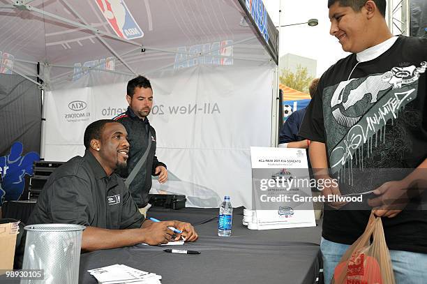 Ty Lawson of the Denver Nuggets signs a autogragh for a fan during the NBA Nation Mobile Basketball Tour on May 8, 2010 at the ÒCinco De Mayo...