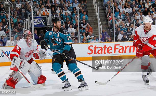 Johan Franzen and Jimmy Howard of the Detroit Red Wings follow the puck while Joe Thornton of the San Jose Sharks looks on in Game Five of the...