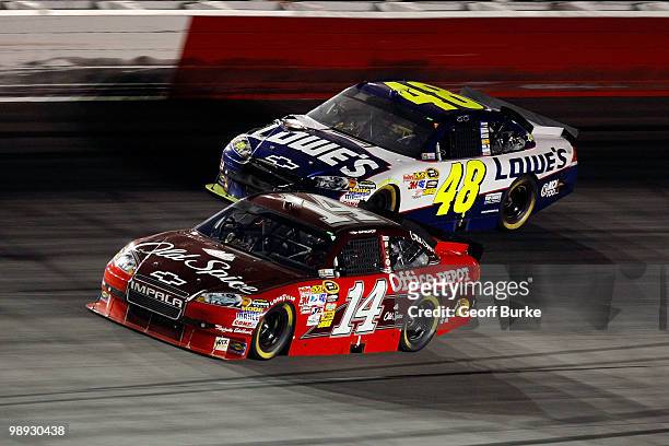 Tony Stewart, driver of the Old Spice / Office Depot Chevrolet, leads Jimmie Johnson, driver of the Lowe's Chevrolet, during the NASCAR Sprint Cup...