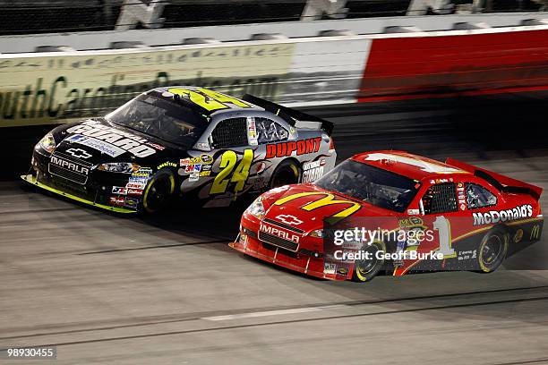 Jeff Gordon, driver of the DuPont National Guard Facebook Chevrolet races side by each against Jamie McMurray, driver of the McDOnald's Chevrolet...