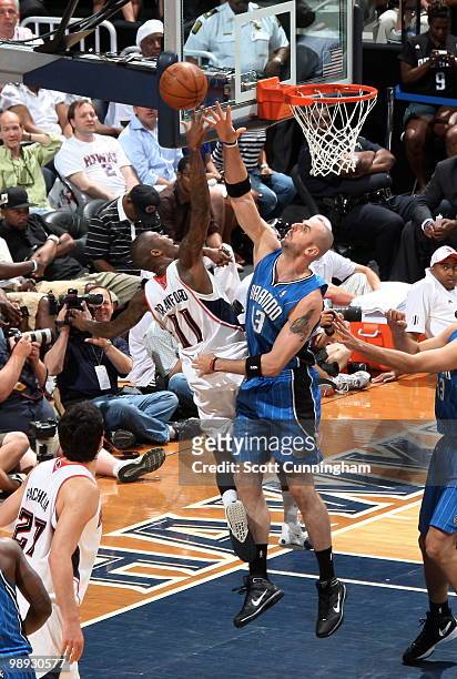 Jamal Crawford of the Atlanta Hawks puts up a shot against Marcin Gortat of the Orlando Magic in Game Three of the Eastern Conference Semifinals...
