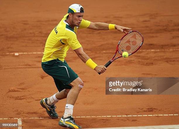 Lleyton Hewitt of Australia plays a backhand during his match against Yuichi Sugita of Japan during the match between Australia and Japan on day...