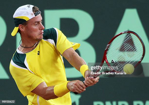 Lleyton Hewitt of Australia plays a backhand during his match against Yuichi Sugita of Japan during the match between Australia and Japan on day...