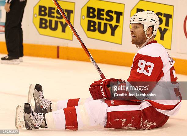 Johan Franzen of the Detroit Red Wings lies on the ice against the San Jose Sharks skates in Game Five of the Western Conference Semifinals during...