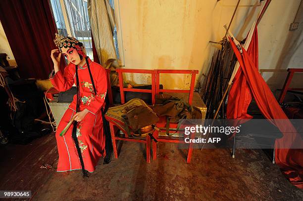 Young Chinese opera performer from the Anhui art college waits for her turn on stage at a rehearsal for a Peking Opera performance at their school in...