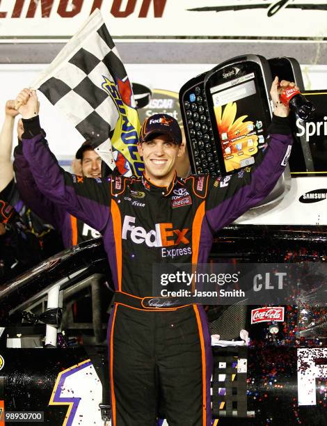 Denny Hamlin, driver of the FedEx Express Toyota, celebrates in victory lane after he won the NASCAR Sprint Cup series SHOWTIME Southern 500 at...