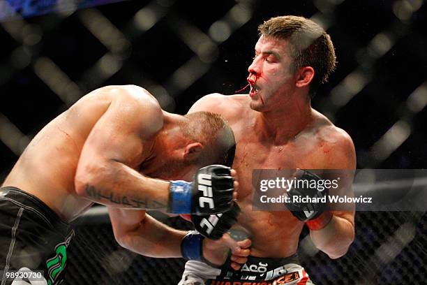 Jeremy Stephens punches Sam Stout in the stomach in their lightweight "swing" bout at UFC 113 at Bell Centre on May 8, 2010 in Montreal, Quebec,...