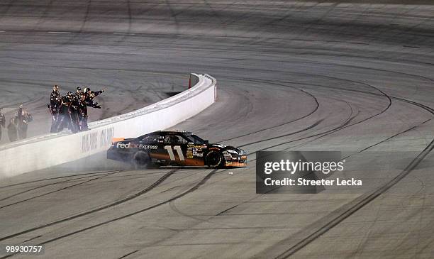 Denny Hamlin, driver of the FedEx Express Toyota, celebrates with his crew after winning the NASCAR Sprint Cup series SHOWTIME Southern 500 at...