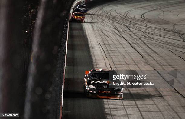Denny Hamlin, driver of the FedEx Express Toyota, leads a pack of cars on his way to a win at the NASCAR Sprint Cup series SHOWTIME Southern 500 at...
