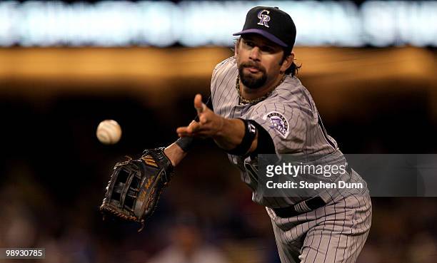 First baseman Todd Helton of the Colorado Rockies flips the ball to first to force out Matt Kemp of the Los Angeles Dodgers to end the fifth inning...