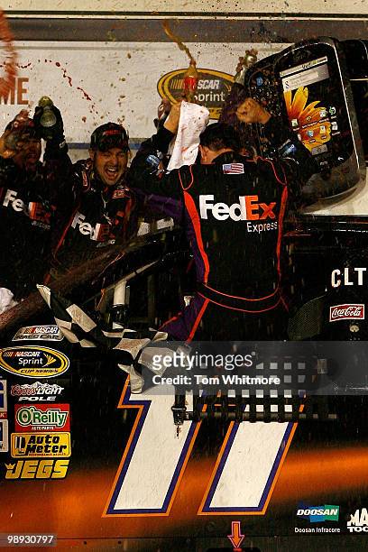 Denny Hamlin, driver of the FedEx Express Toyota, celebrates with his crew in victory lane after he won the NASCAR Sprint Cup series SHOWTIME...