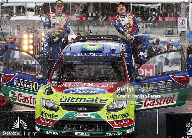 Co-driver Miikka Anttila celebrates with Jari-Matti Latvala of Finland after winning the WRC Rally of New Zealand on May 9, 2010 in Auckland, New...