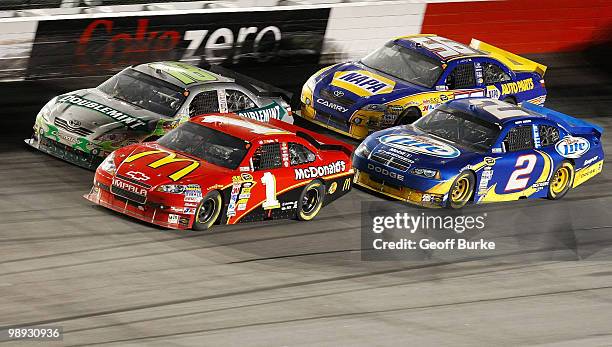 Jamie McMurray, driver of the McDonald's Chevrolet, races Kyle Busch, driver of the Doublemint Toyota, Kurt Busch, driver of the Miller Lite Dodge,...