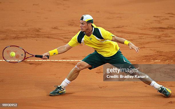 Lleyton Hewitt of Australia stretches out to play a forehand during his match against Yuichi Sugita of Japan during the match between Australia and...