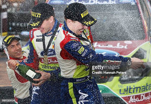 Co-driver Miikka Anttila celebrates with Jari-Matti Latvala of Finland after winning the WRC Rally of New Zealand on May 9, 2010 in Auckland, New...