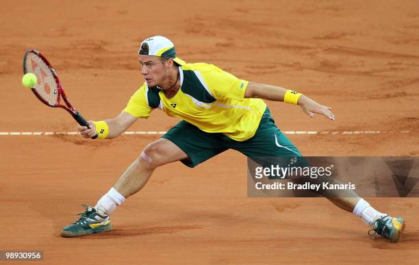 Lleyton Hewitt of Australia stretches out to play a forehand during his match against Yuichi Sugita of Japan during the match between Australia and...