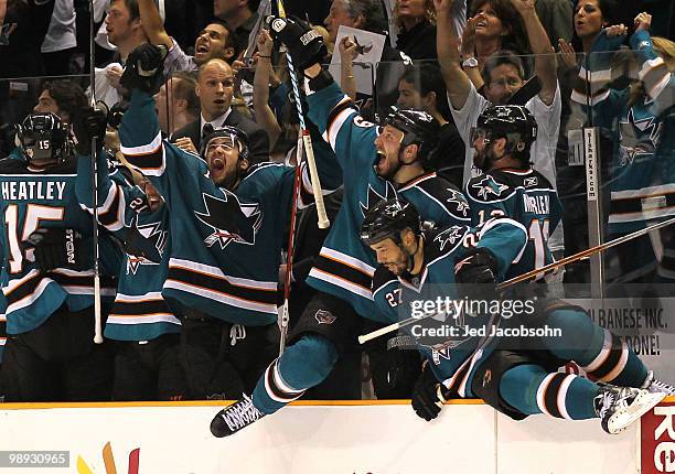 Devin Setoguchi, Ryan Clowe and Manny Malhotra of the San Jose Sharks celebrate after defeating the Detroit Red Wings in Game Five of the Western...