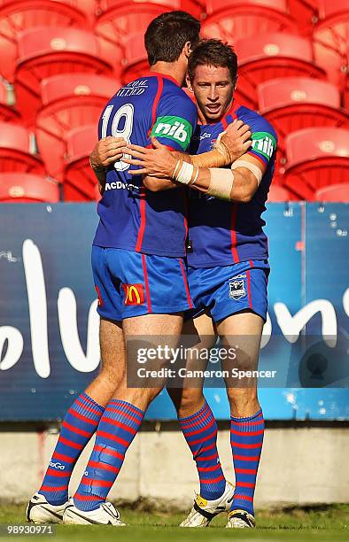 Kurt Gidley of the Knights is congratulated by team mate Cameron Ciraldo after scoring a try during the round nine NRL match between the Newcastle...