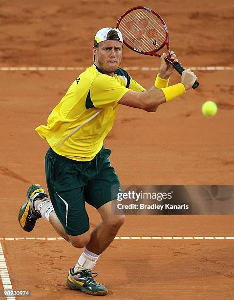 Lleyton Hewitt of Australia prepares to volley during his match against Yuichi Sugita of Japan during the match between Australia and Japan on day...