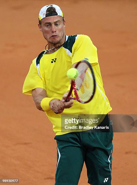 Lleyton Hewitt of Australia plays a backhand during his match against Yuichi Sugita of Japan during the match between Australia and Japan on day...