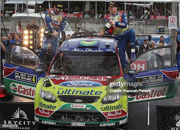 Co-driver Miikka Anttila celebrates with Jari-Matti Latvala of Finland after winning the WRC Rally of New Zealand on May 9, 2010 in Auckland, New...