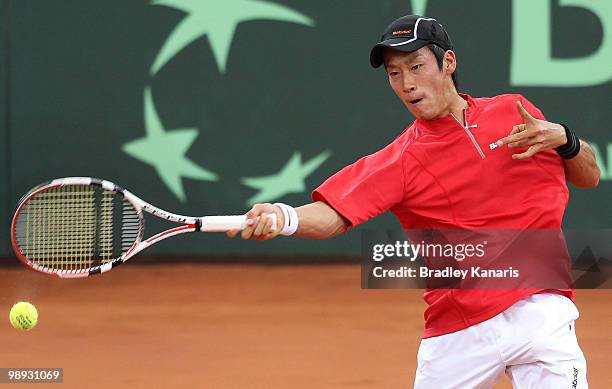 Yuichi Sugita of Japan plays a forehand during his match against Lleyton Hewitt of Australia during the match between Australia and Japan on day...