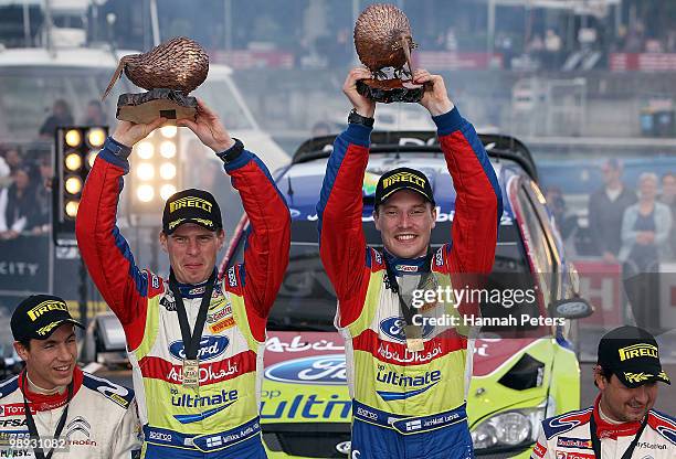 Co-driver Miikka Anttila celebrates with Jari-Matti Latvala of Finland after winning the WRC Rally of New Zealand on May 9, 2010 in Auckland, New...