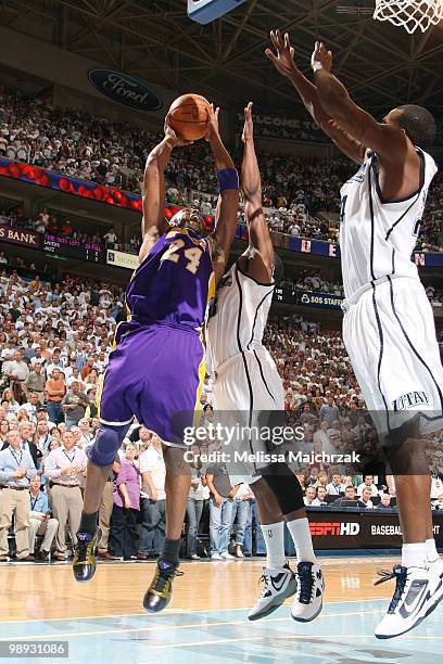 Kobe Bryant of the Los Angeles Lakers puts the shot up over Wesely Mathews and Paul Millsap of the Utah Jazz in Game Three of the Western Conference...