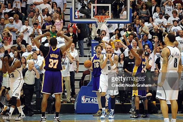 Pau Gasol, Kobe Bryant and Ron Artest of the Los Angeles Lakers celebrate their win against Carlos Boozer and Deron Williams of the Utah Jazz in Game...