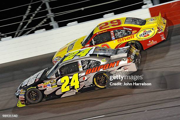 Jeff Gordon, driver of the DuPont / National Guard Facebook Chevrolet, races Kevin Harvick, driver of the Shell Pennzoil Chevrolet during the NASCAR...