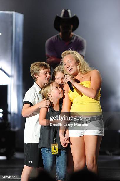 Tim McGraw performs a song with his children at Cruzan Amphitheatre on May 8, 2010 in West Palm Beach, Florida.