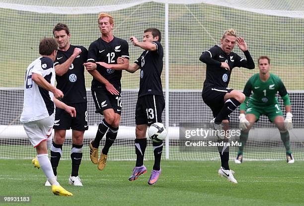 Allan Pearce of NZFC All Stars takes a freekick as Tim Brown, Aaron Clapham, Costa Barbarouses and David Mulligan of New Zealand A defend during a...