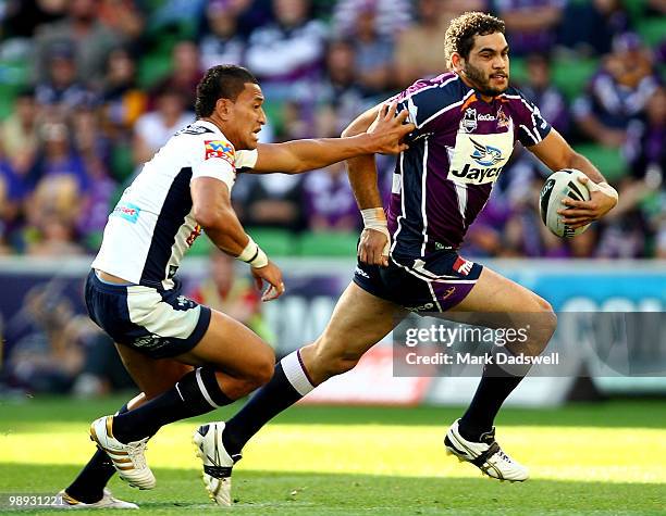 Greg Inglis of the Storm fends off Israel Folau of the Broncos during the round nine NRL match between the Melbourne Storm and the Brisbane Broncos...