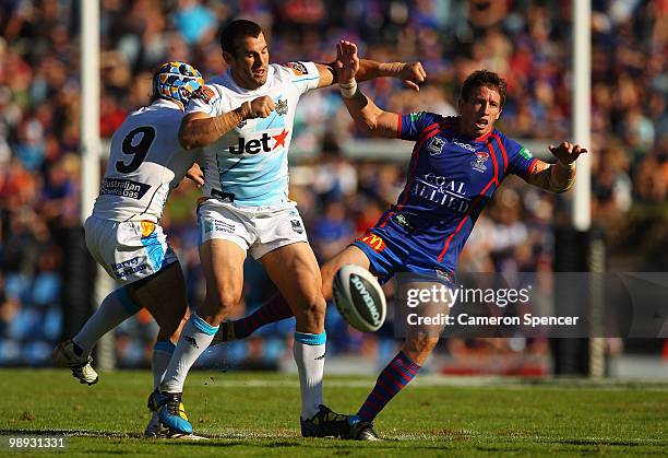 Knights captain Kurt Gidley is charged out of the way by Anthony Laffranchi after kicking the ball during the round nine NRL match between the...