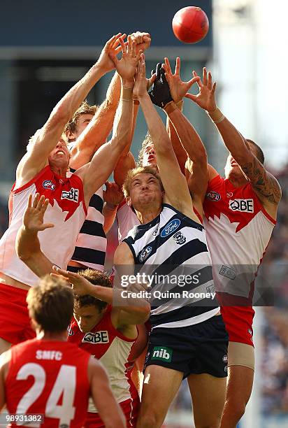 Jesse White of the Swans attempts to mark over Darren Milburn of the Cats during the round seven AFL match between the Geelong Cats and the Sydney...