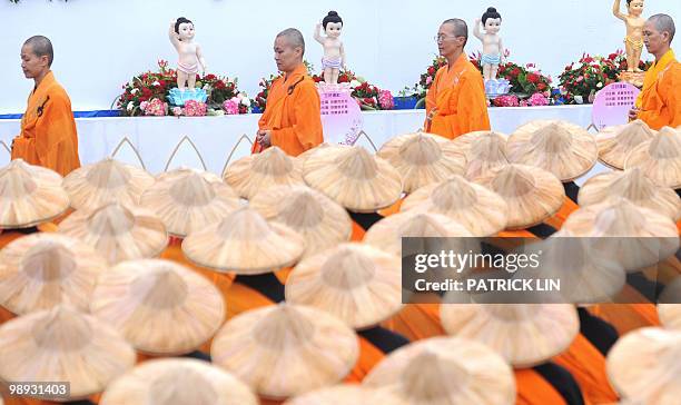 Buddhist monks in saffron robes gather during a ceremony held in Taipei on May 9, 2010. The event was part of the local celebrations of Buddha's...