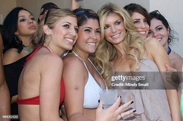 Model Marisa Miller poses with fans at a a pool party hosted by Marisa Miller at Wet Republic on May 8, 2010 in Las Vegas, Nevada.